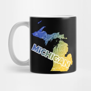 Colorful mandala art map of Michigan with text in blue and yellow Mug